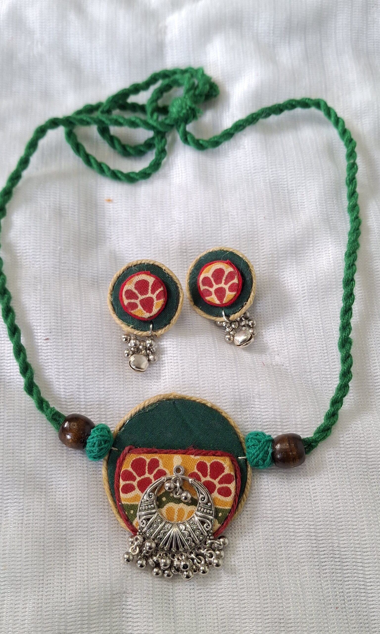 green handcrafted fabric choker set with oxidised pendant & stud earrings green handcrafted fabric choker set with oxidised pendant & stud earrings